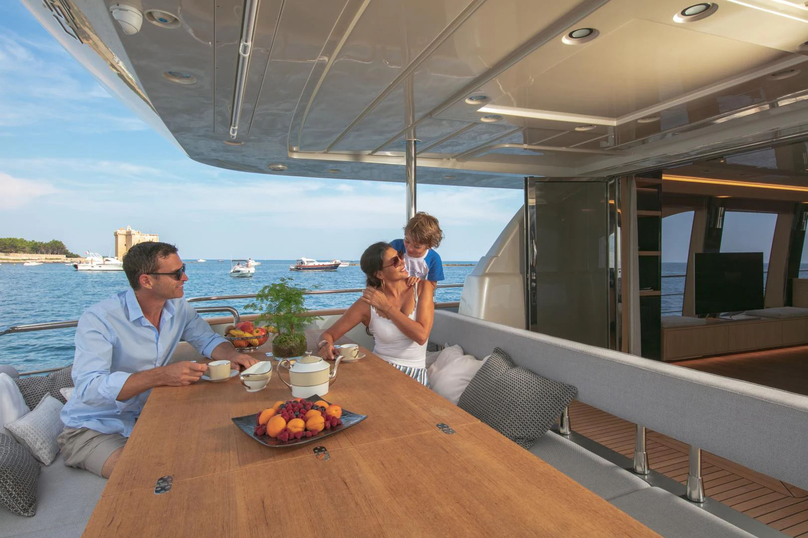 a family sitting at a table aboard URSUS V Yacht for Sale
