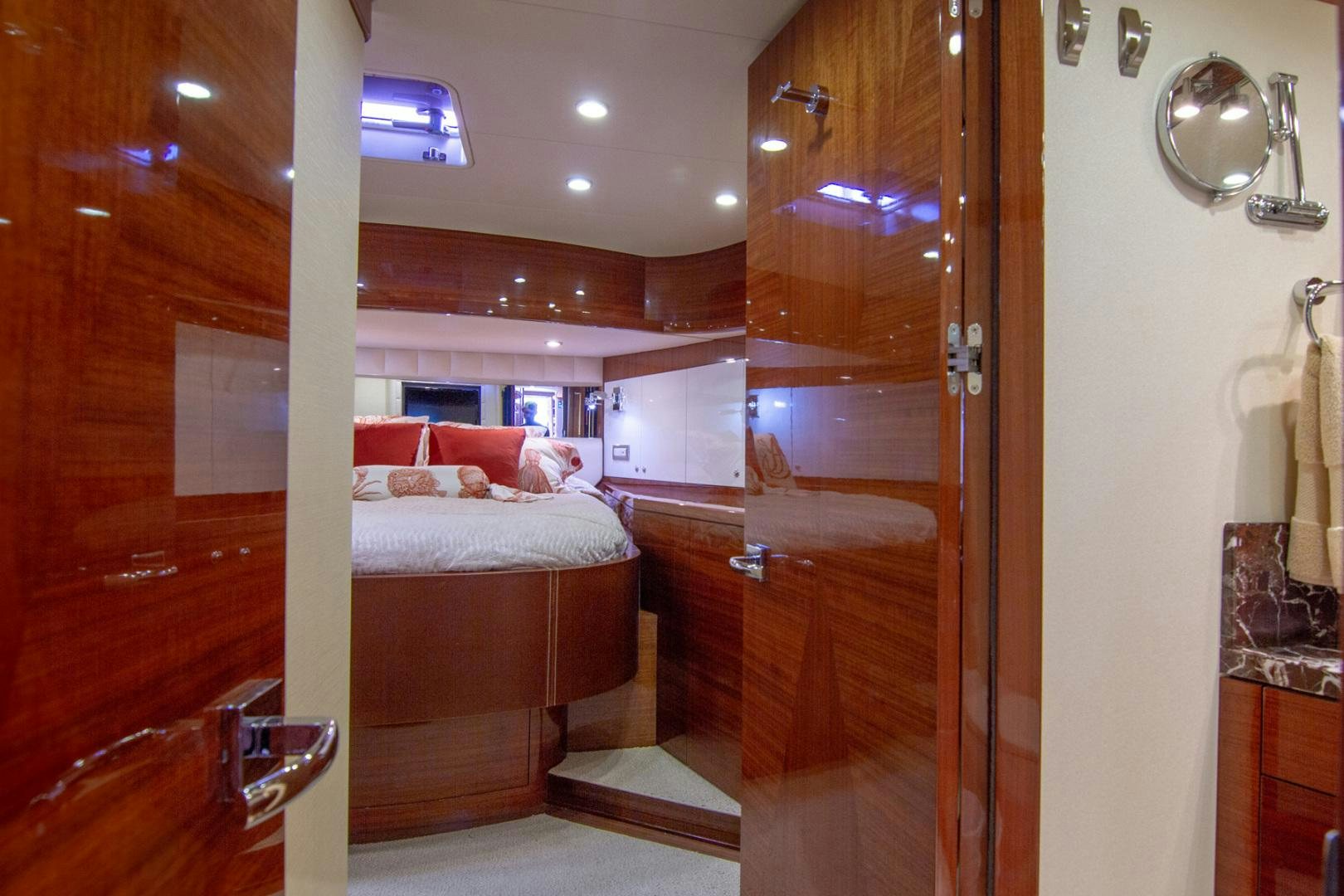 a room with a bed and a mirror aboard BRAVO Yacht for Sale