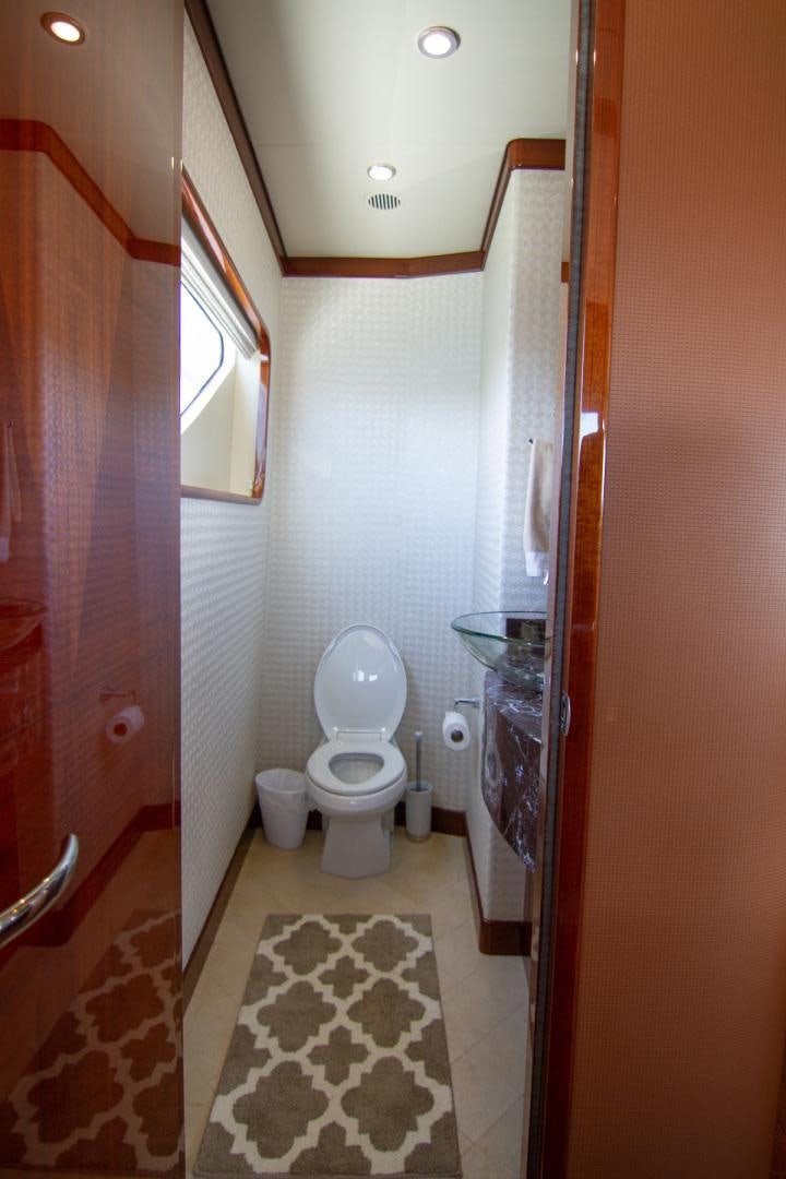 a bathroom with a toilet and a sink aboard BRAVO Yacht for Sale