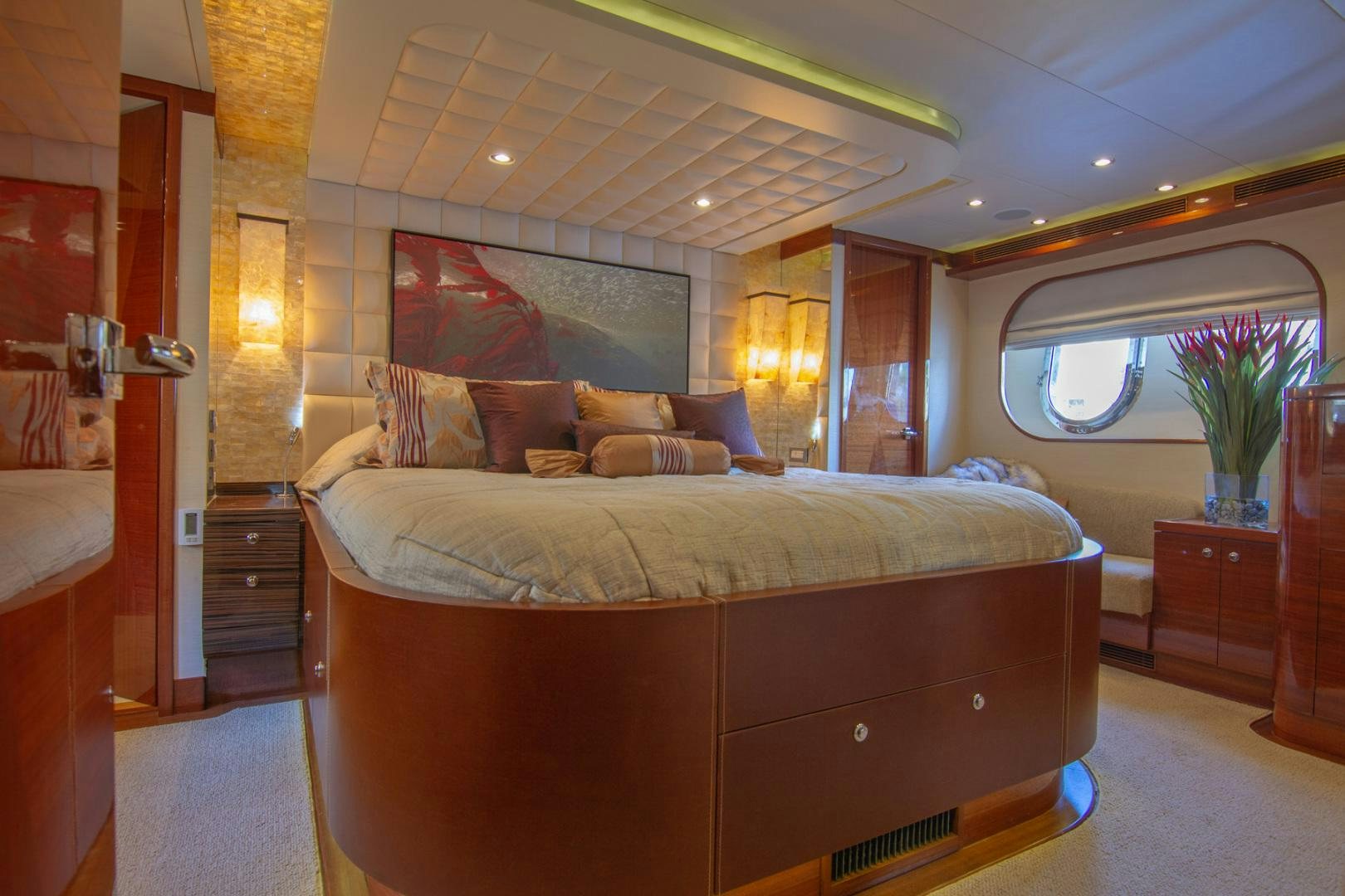 a large bed in a room aboard BRAVO Yacht for Sale