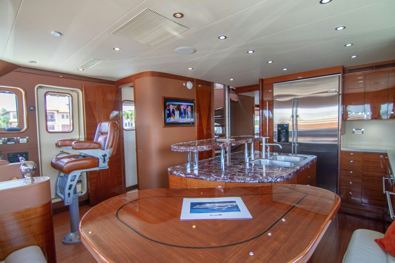a room with a table and chairs aboard BRAVO Yacht for Sale