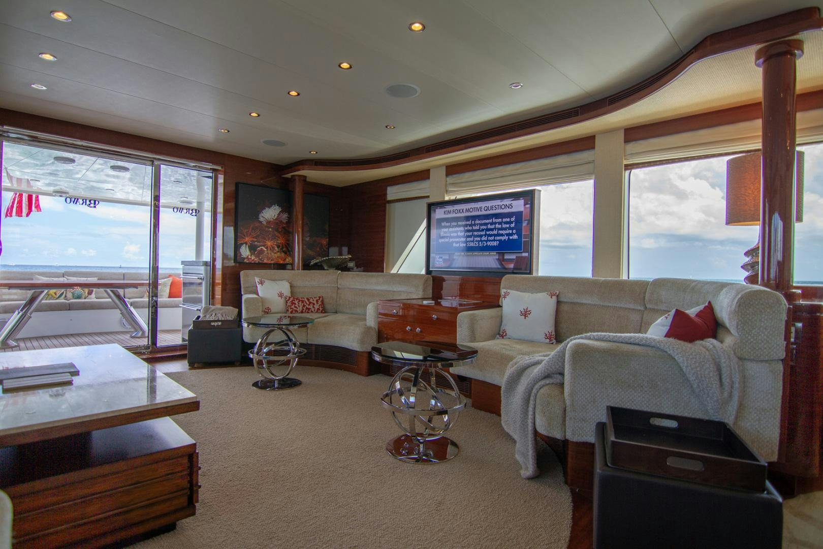 a living room with a large window aboard BRAVO Yacht for Sale
