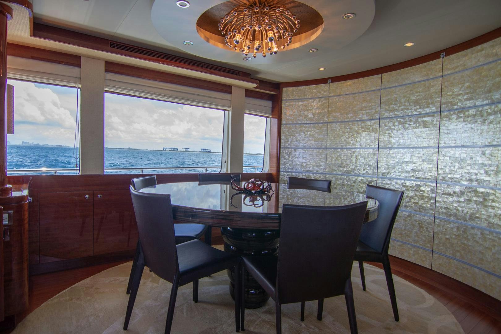 a dining room with a table and chairs aboard BRAVO Yacht for Sale