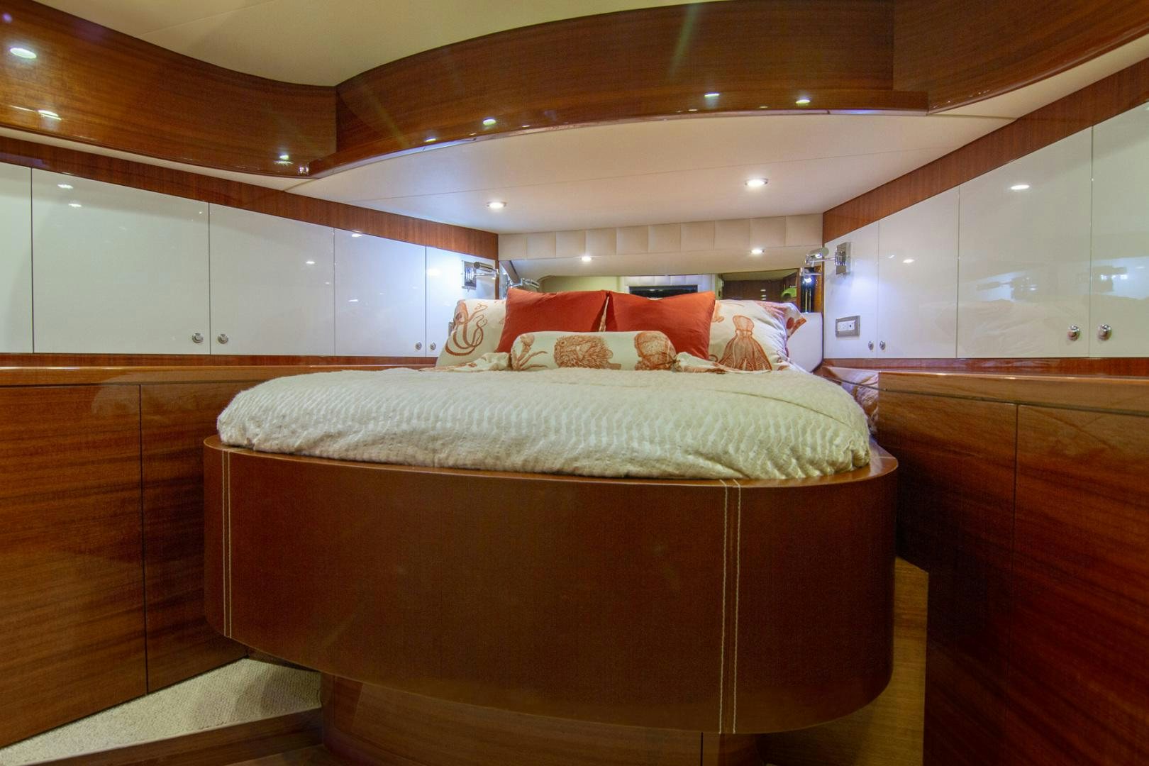 a bed with a wooden headboard aboard BRAVO Yacht for Sale