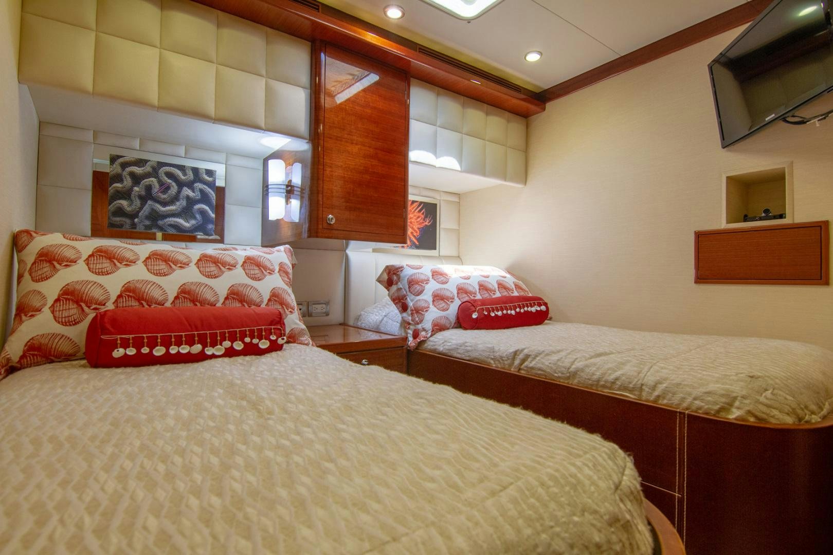 a room with two beds aboard BRAVO Yacht for Sale