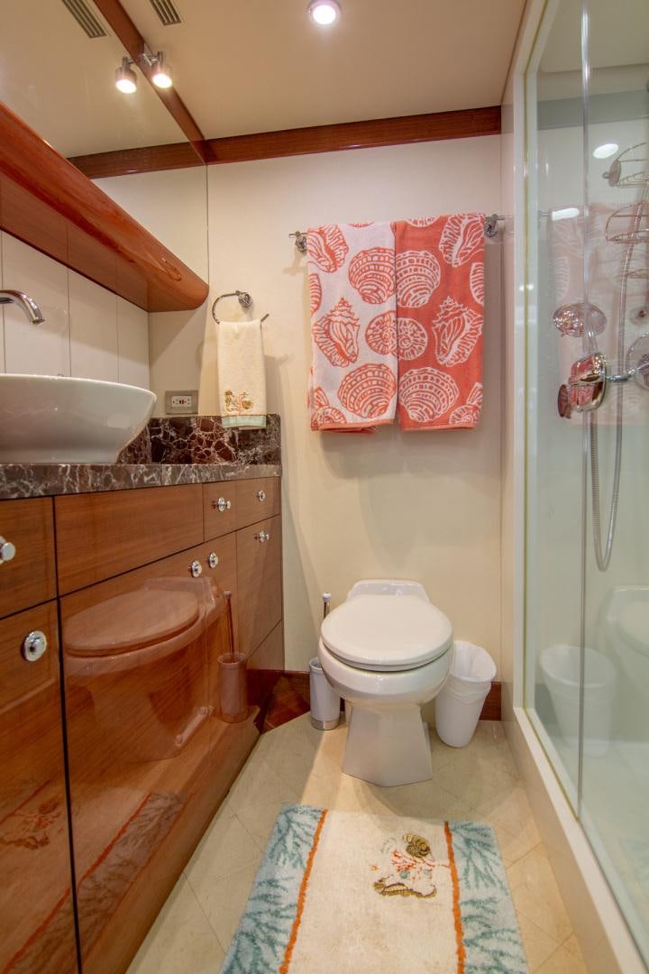 a bathroom with a sink toilet and a shower aboard BRAVO Yacht for Sale