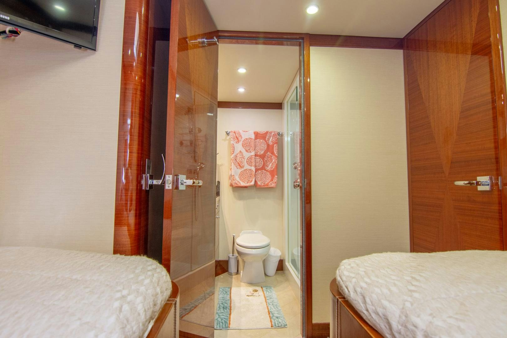 a bathroom with a glass shower aboard BRAVO Yacht for Sale