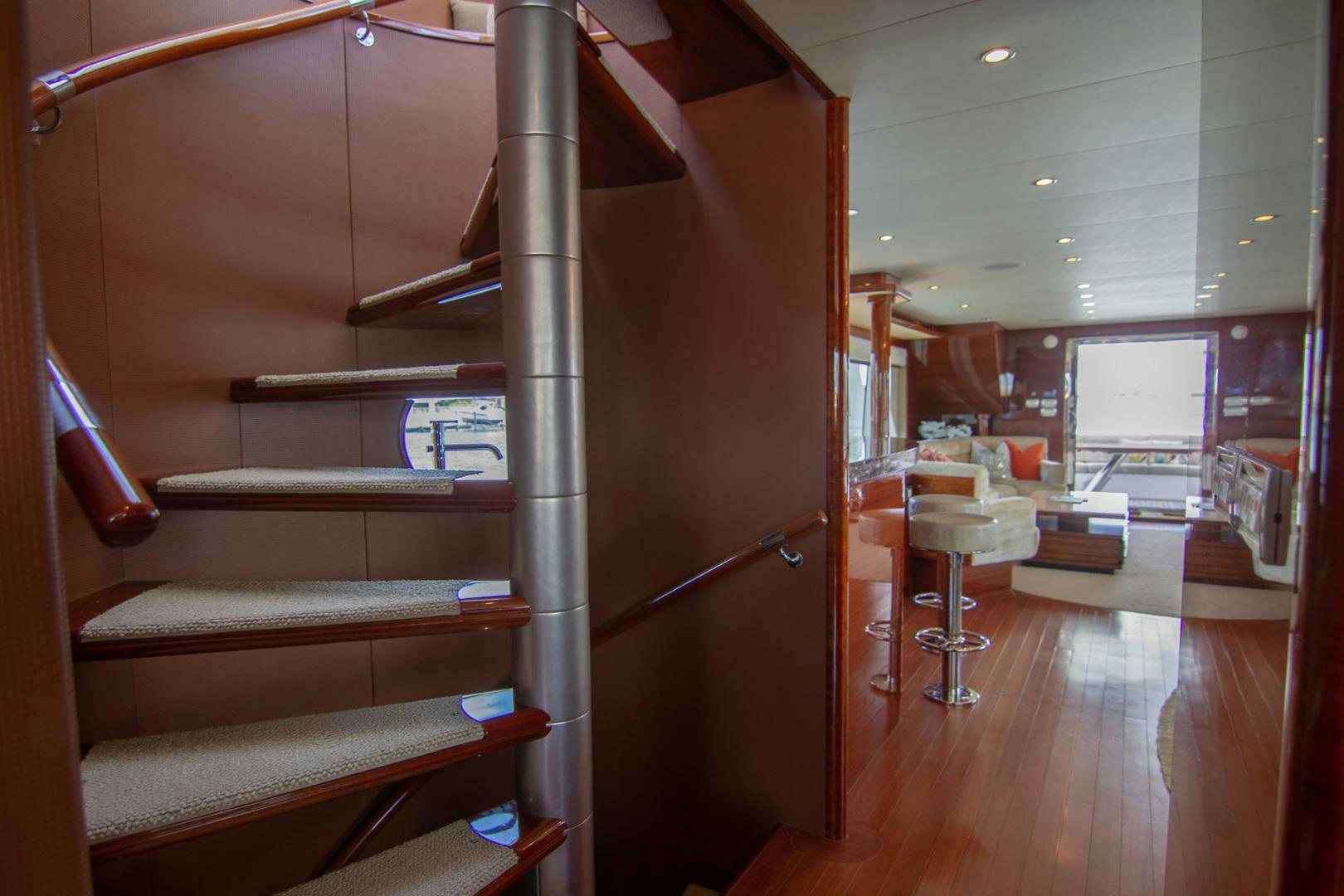 a wood staircase in a room aboard BRAVO Yacht for Sale