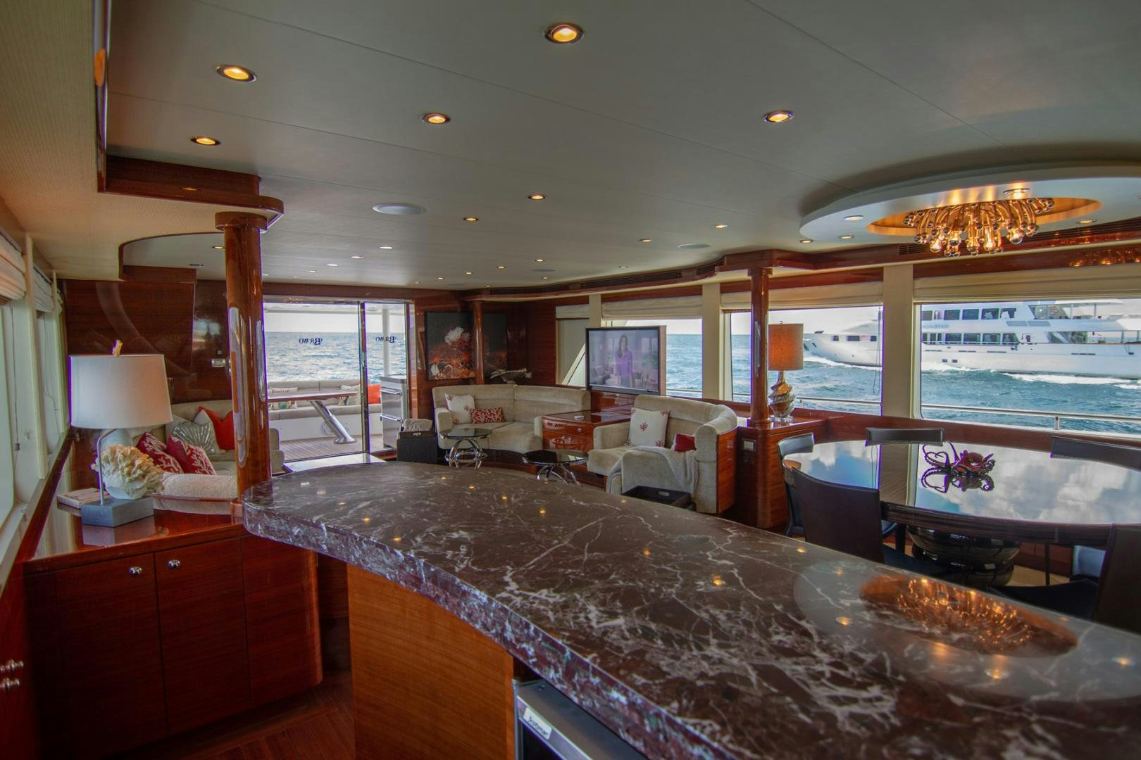 a living room with a large glass window aboard BRAVO Yacht for Sale