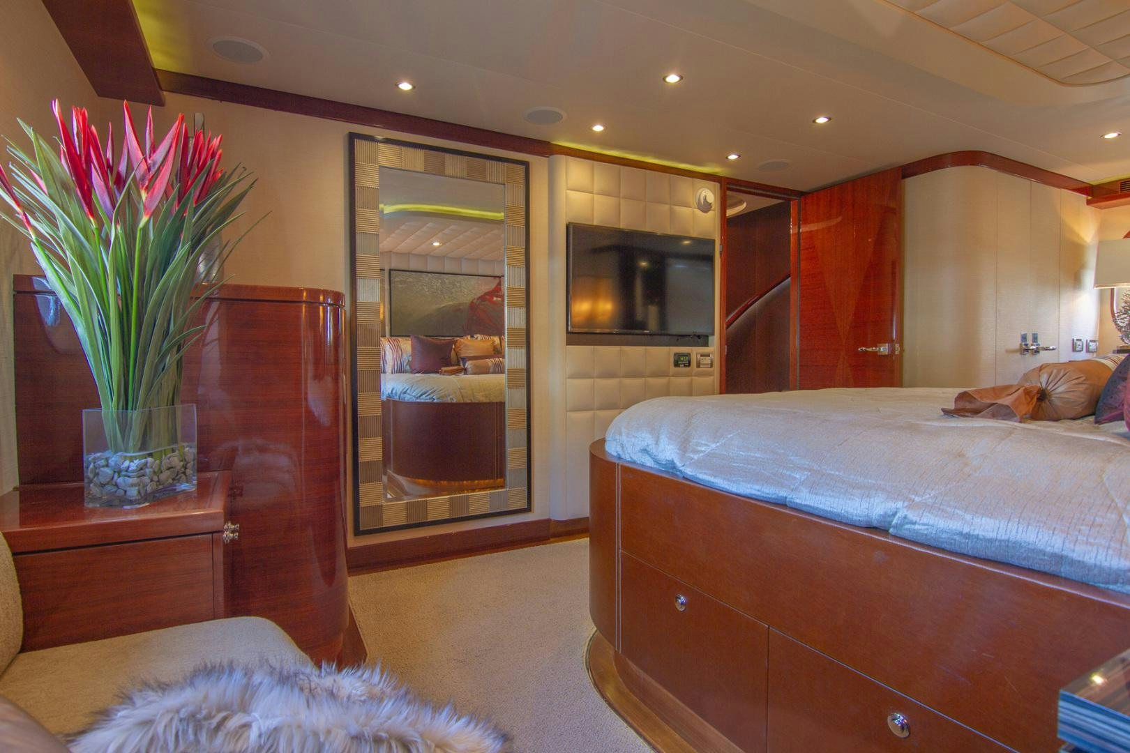 a bedroom with a bed and a table aboard BRAVO Yacht for Sale