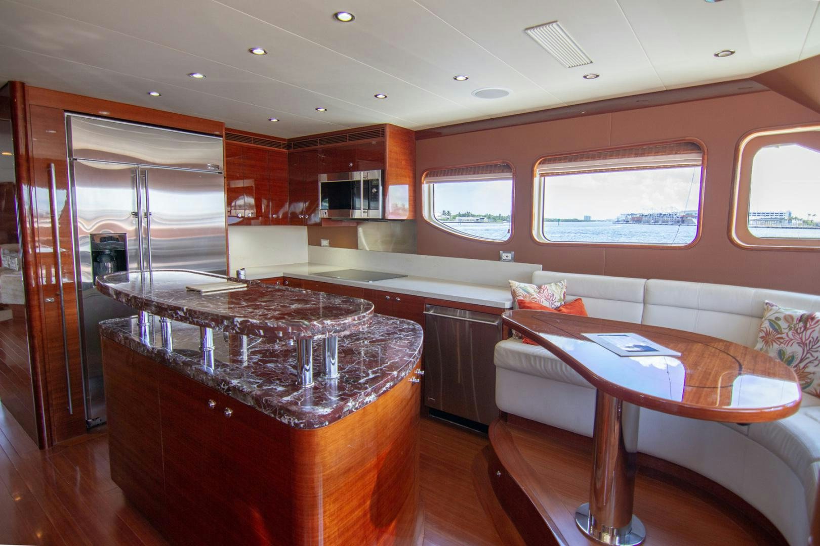 a kitchen with a bar and a table aboard BRAVO Yacht for Sale