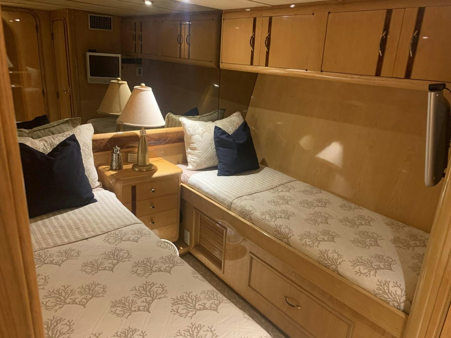 a bed with a wooden headboard aboard REHAB Yacht for Sale