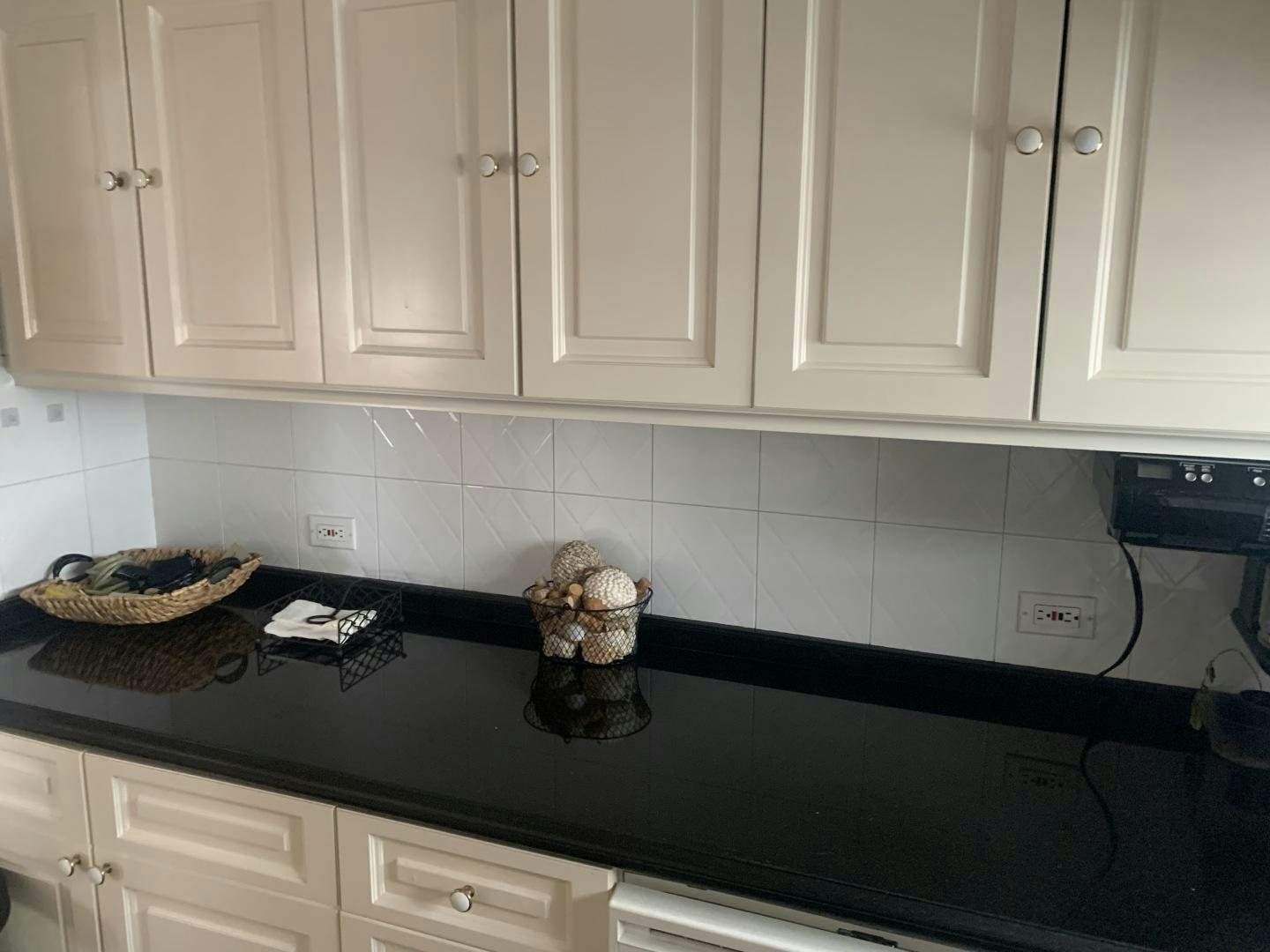 a kitchen counter with white cabinets aboard REHAB Yacht for Sale