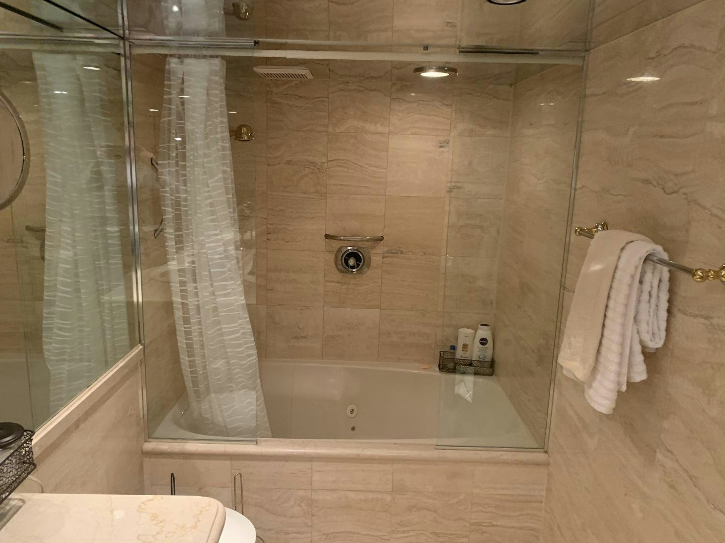 a bathroom with a shower curtain aboard REHAB Yacht for Sale
