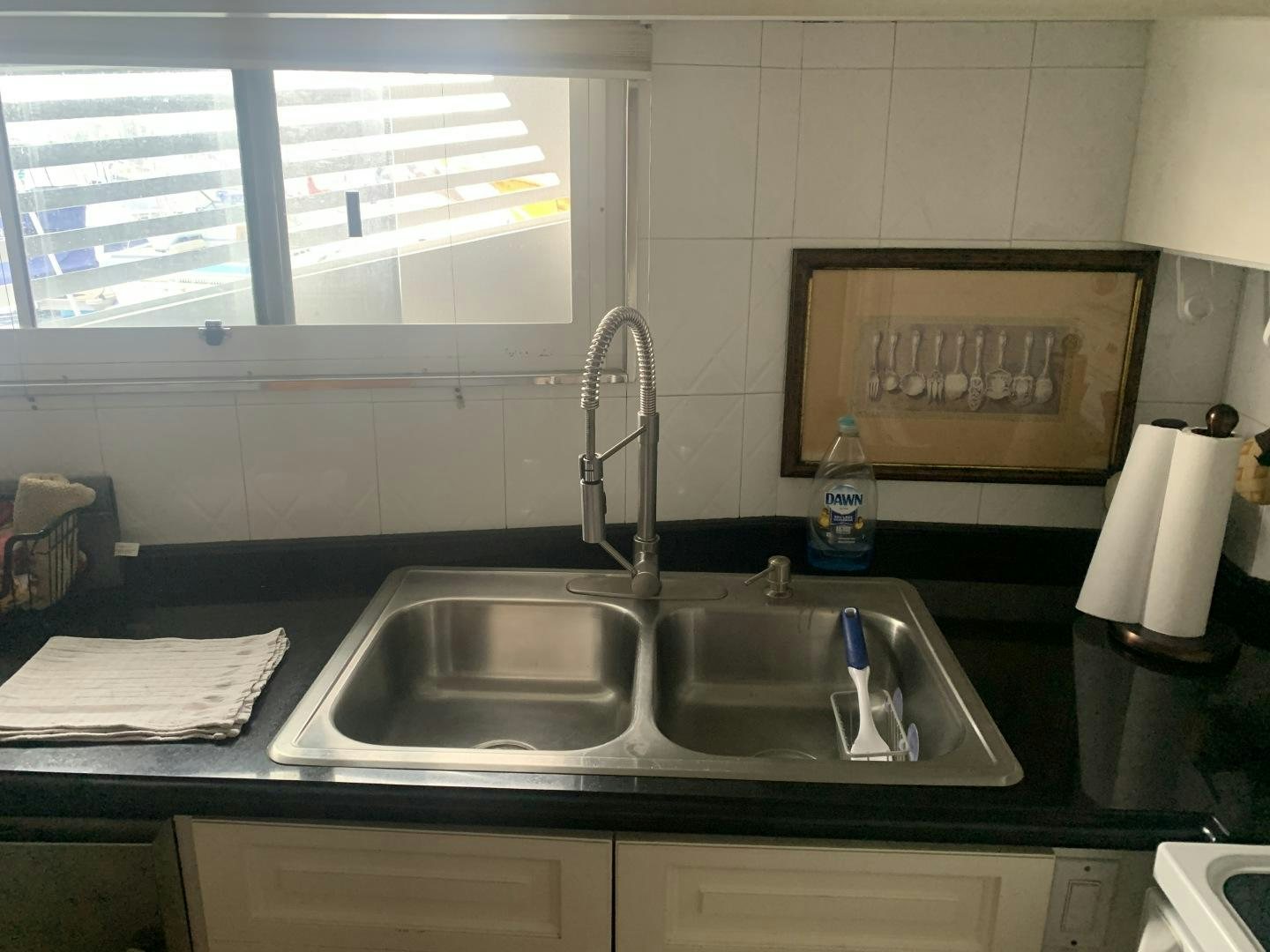a kitchen with a sink and a window aboard REHAB Yacht for Sale