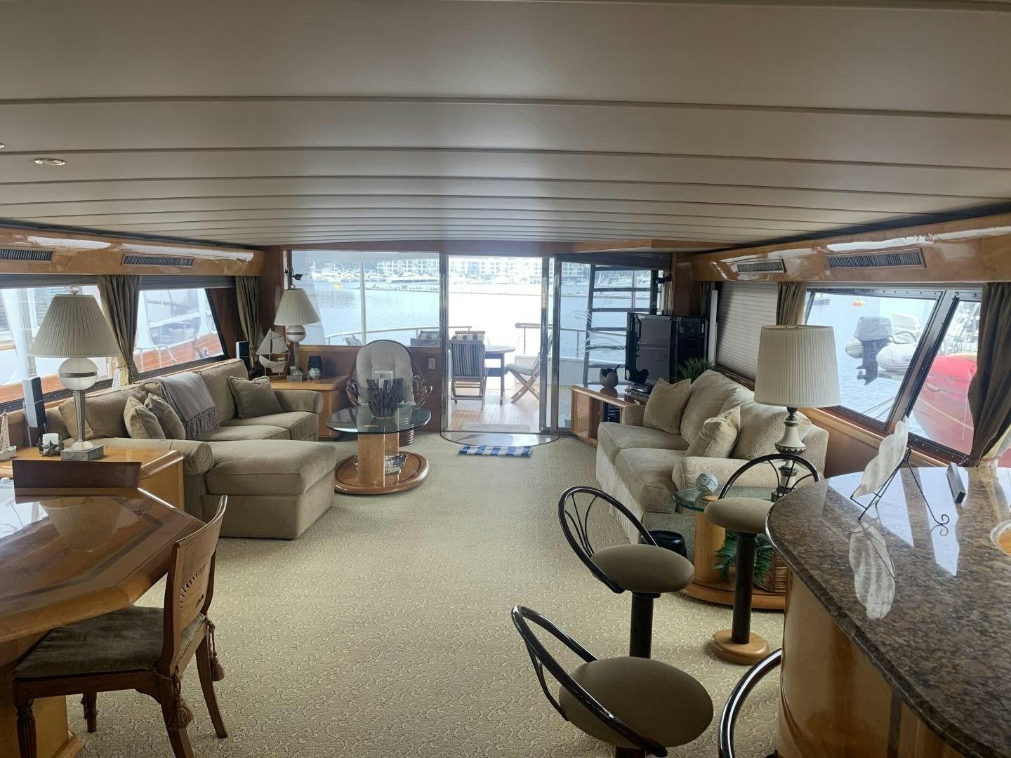 a living room with a large window aboard REHAB Yacht for Sale