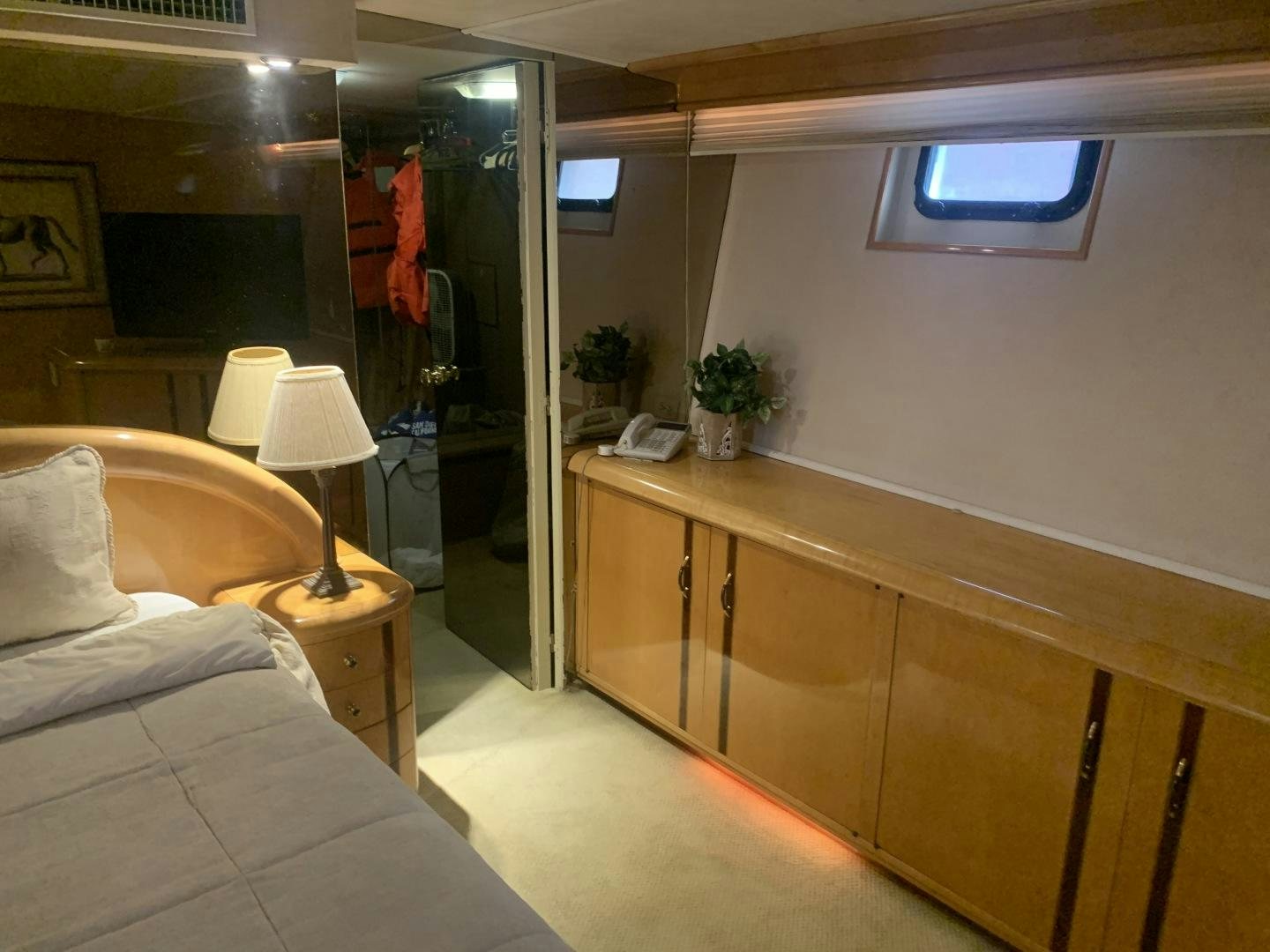 a room with a bed and a mirror aboard REHAB Yacht for Sale