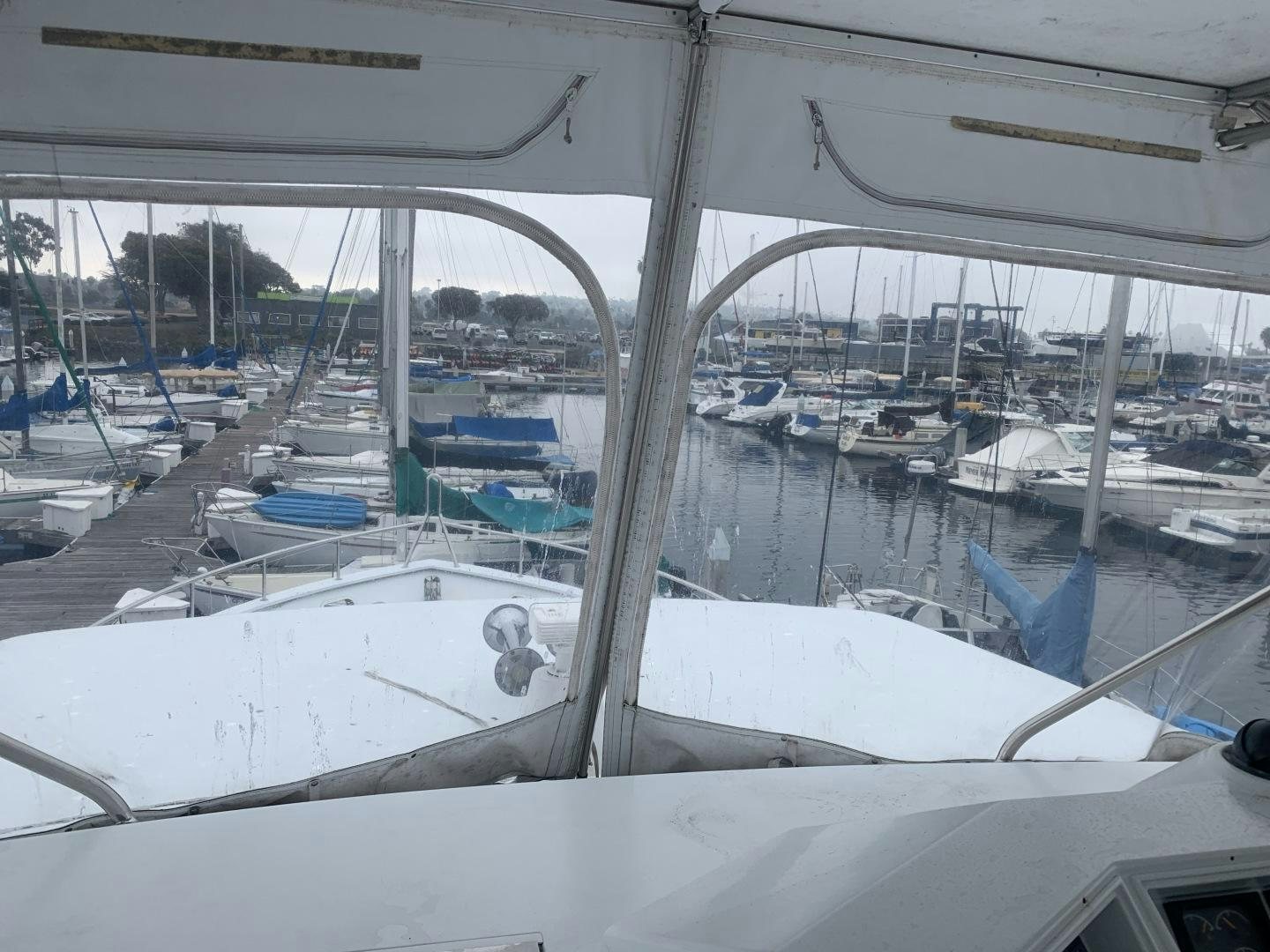 a white boat in a harbor aboard REHAB Yacht for Sale