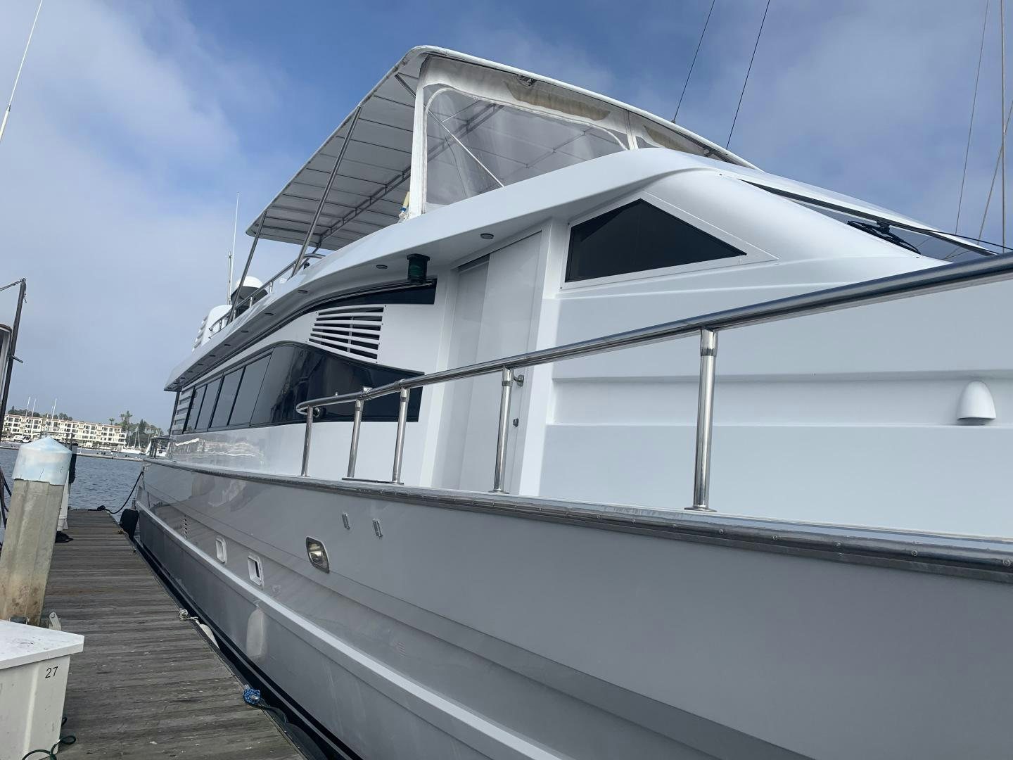 a white yacht docked aboard REHAB Yacht for Sale