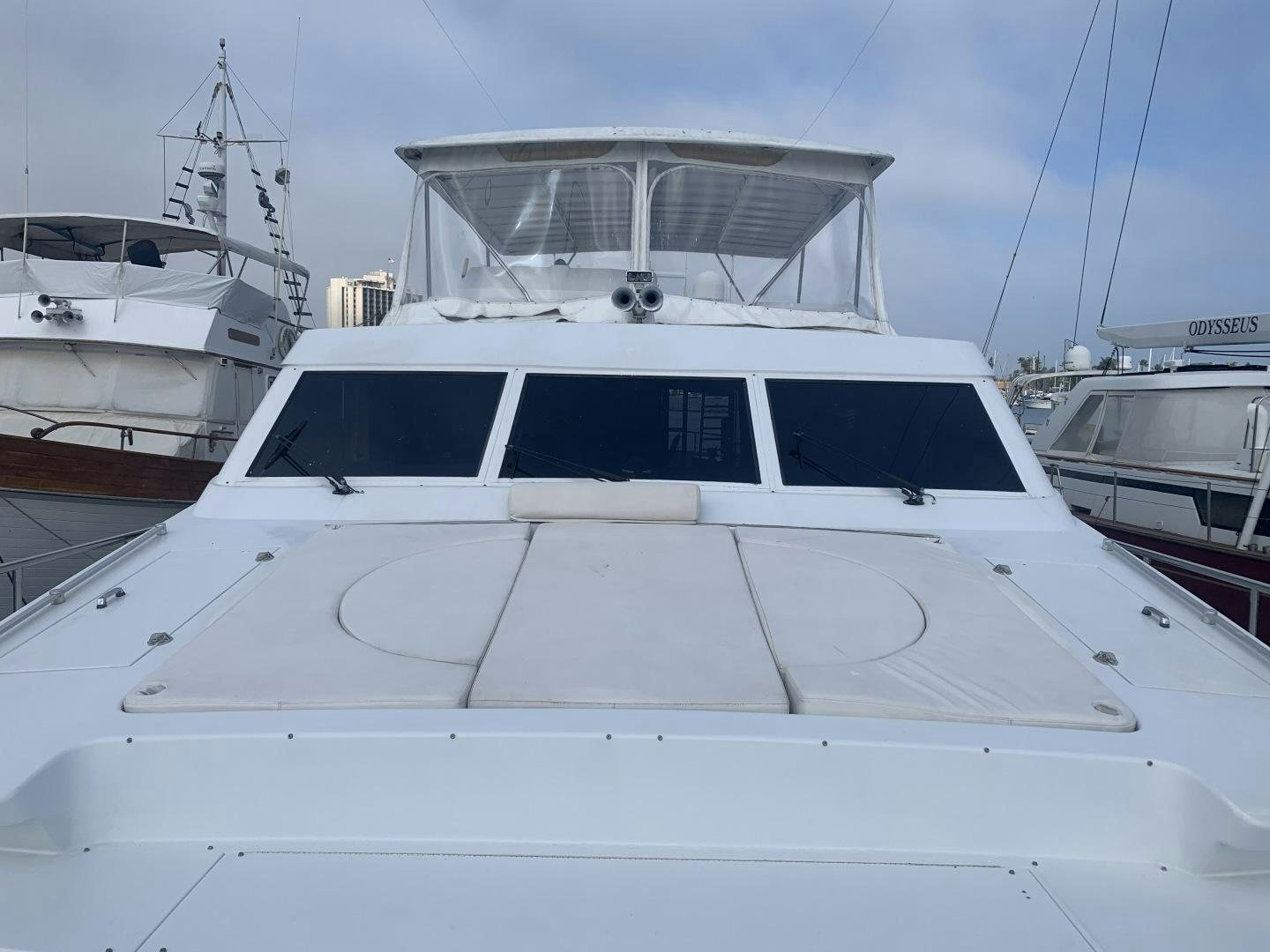 a white yacht in a harbor aboard REHAB Yacht for Sale
