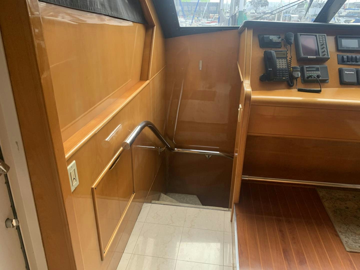 a wooden bunk bed with a telephone on it aboard REHAB Yacht for Sale