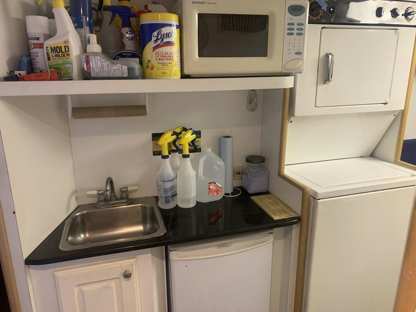 a kitchen with a sink and a microwave aboard REHAB Yacht for Sale
