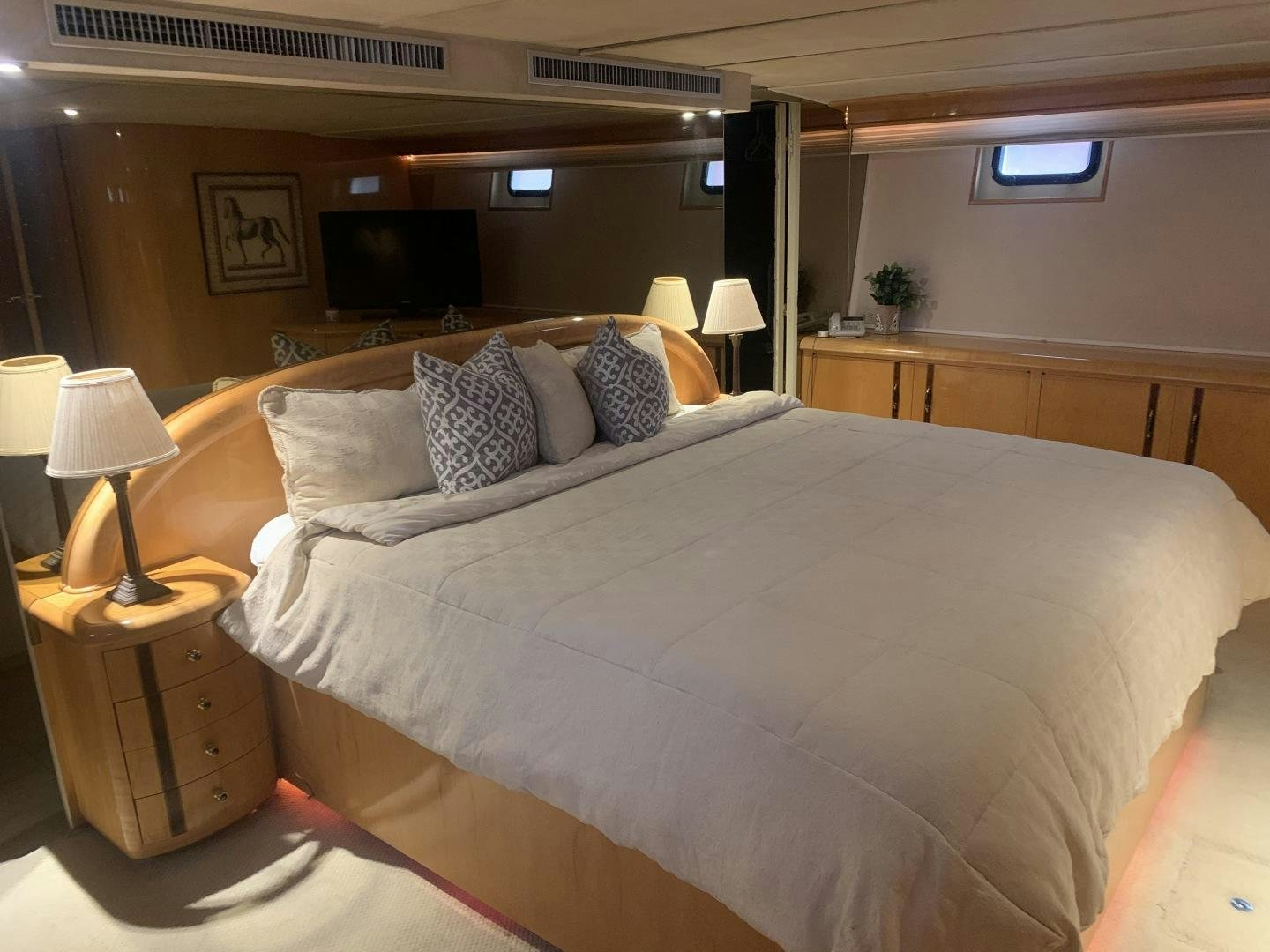 a bed with a white comforter aboard REHAB Yacht for Sale