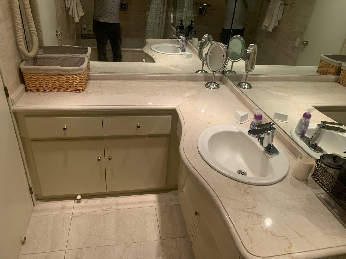 a bathroom with a large mirror aboard REHAB Yacht for Sale