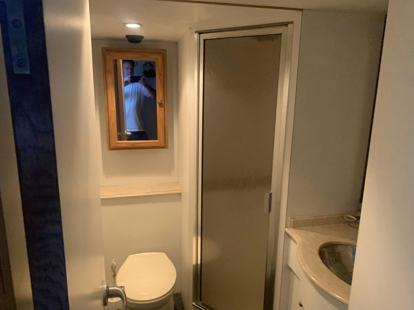 a bathroom with a toilet and a sink aboard REHAB Yacht for Sale