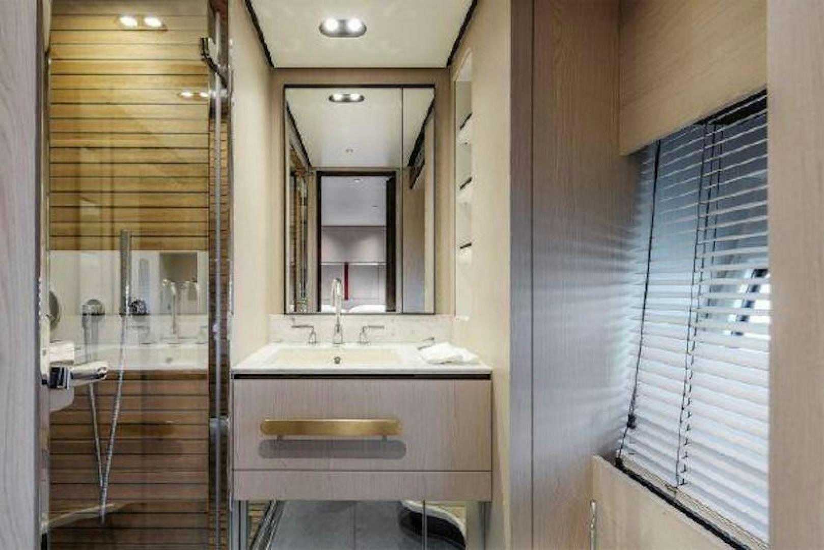 a bathroom with a sink and a mirror aboard NOMAD Yacht for Sale