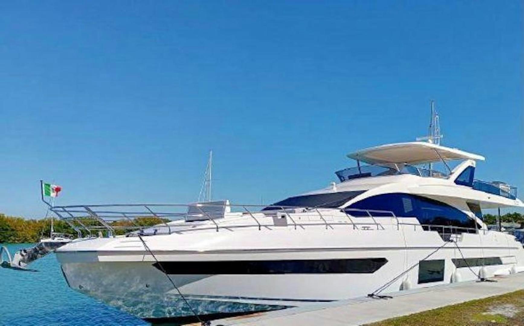 a white boat docked aboard NOMAD Yacht for Sale