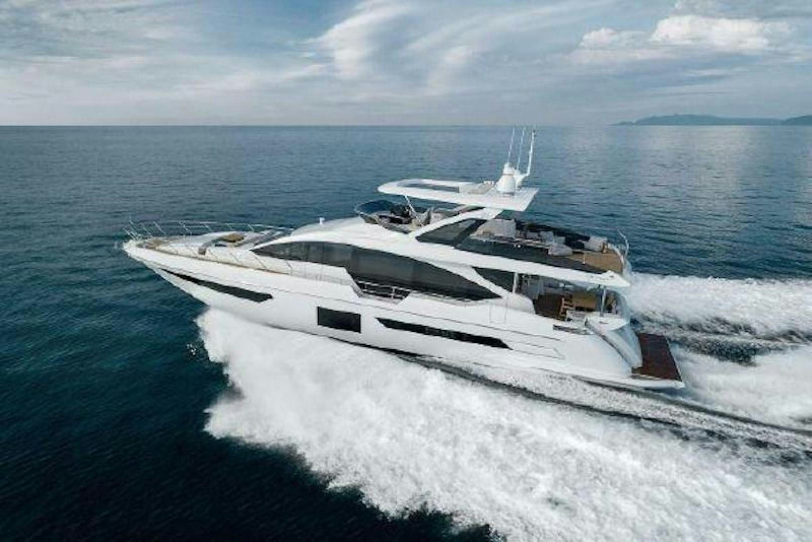 a white yacht on the water aboard NOMAD Yacht for Sale