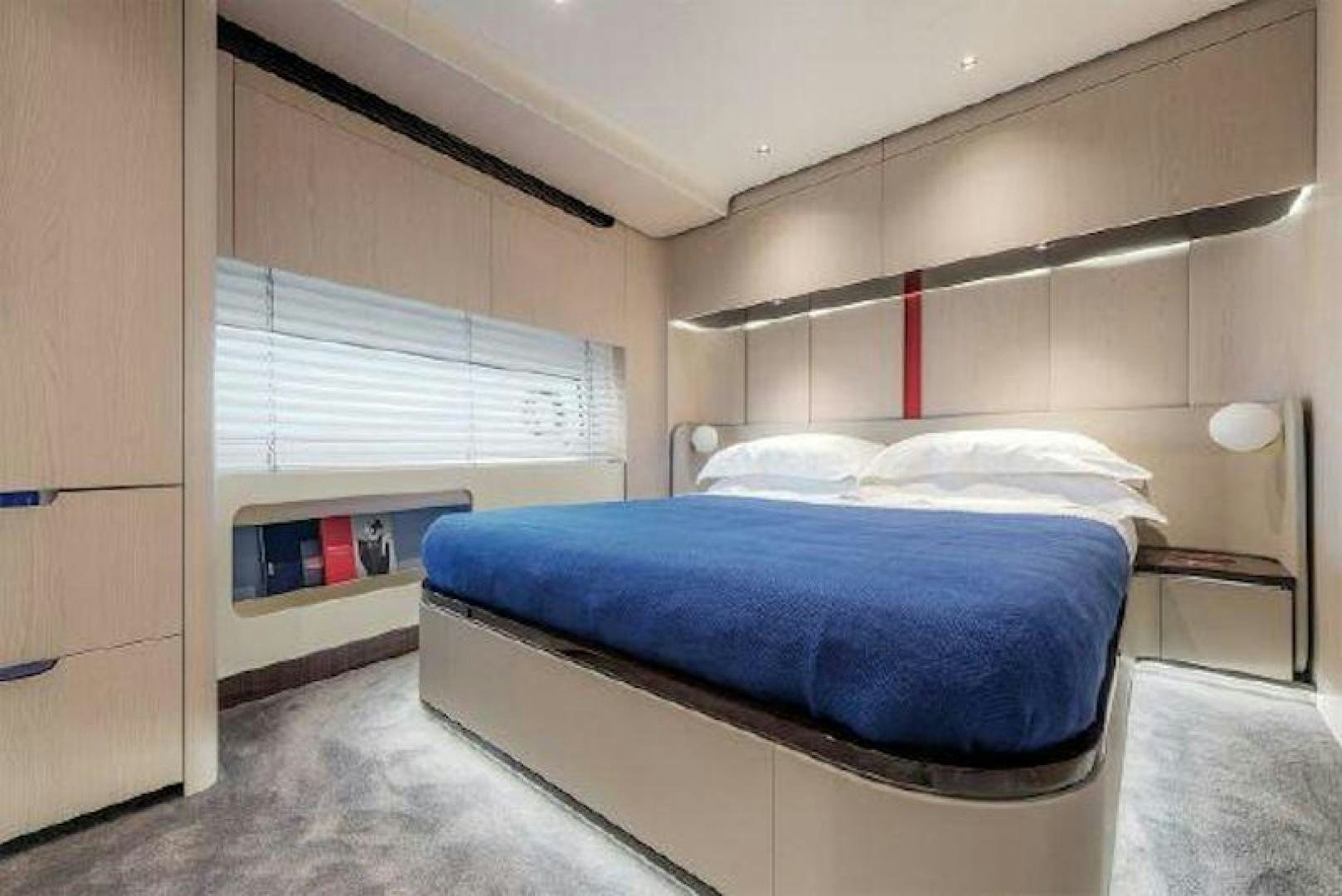 a room with a bed and a window aboard NOMAD Yacht for Sale