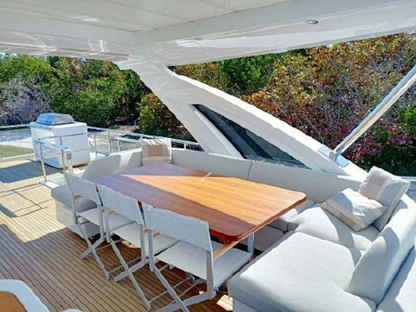 a deck with a table and chairs aboard NOMAD Yacht for Sale