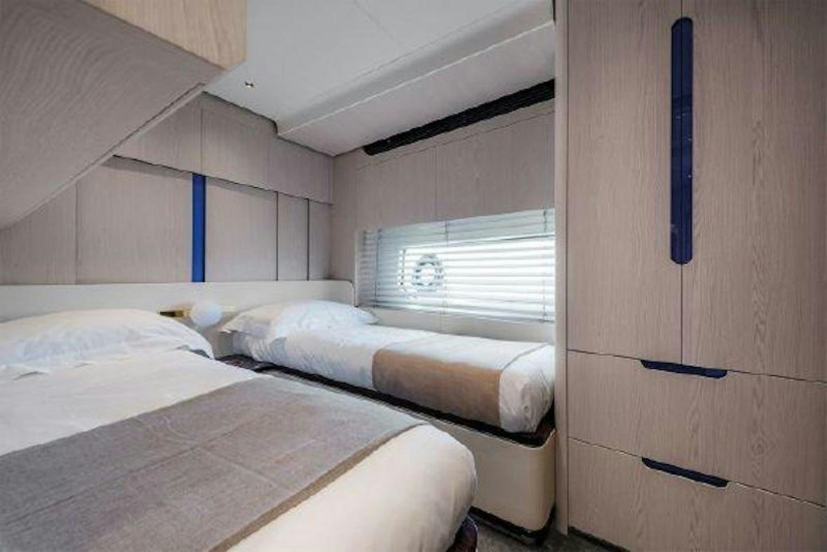 a couple of beds in a room aboard NOMAD Yacht for Sale
