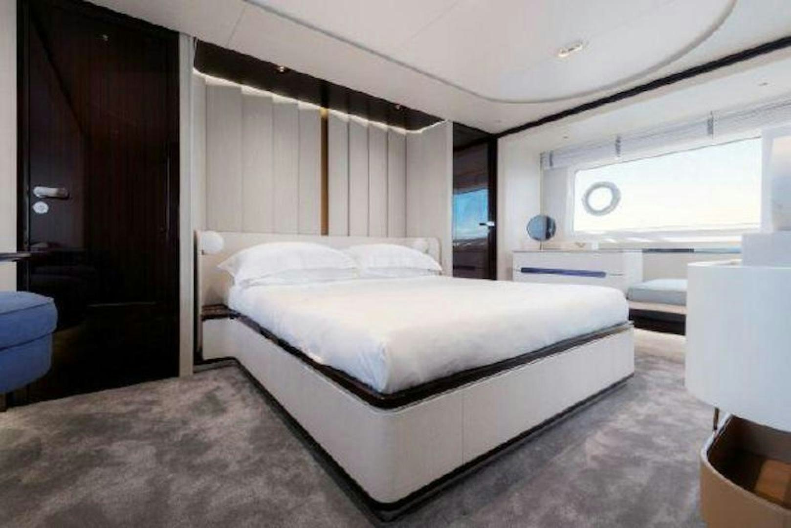 a room with a bed and a window aboard NOMAD Yacht for Sale