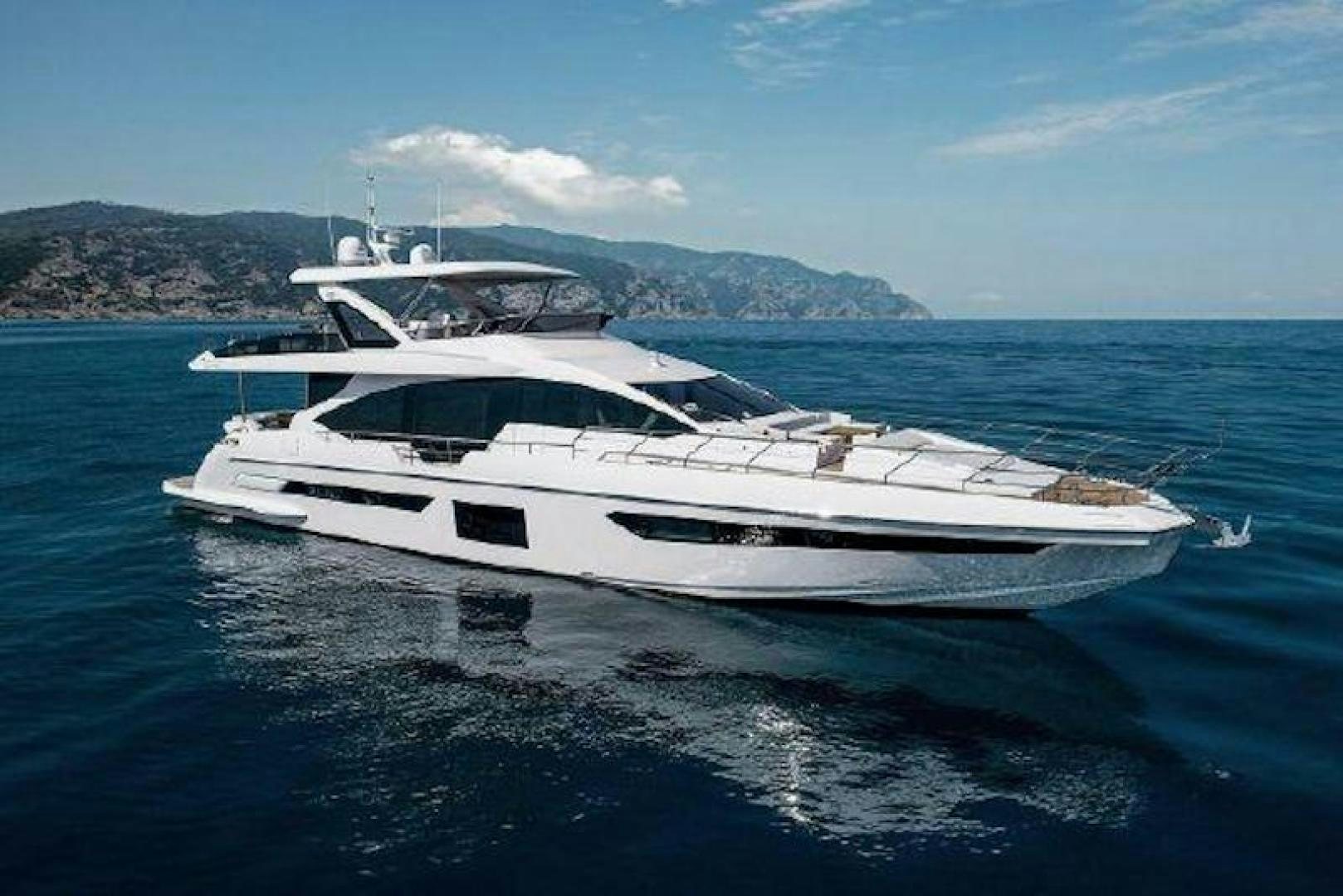 a white yacht in the water aboard NOMAD Yacht for Sale