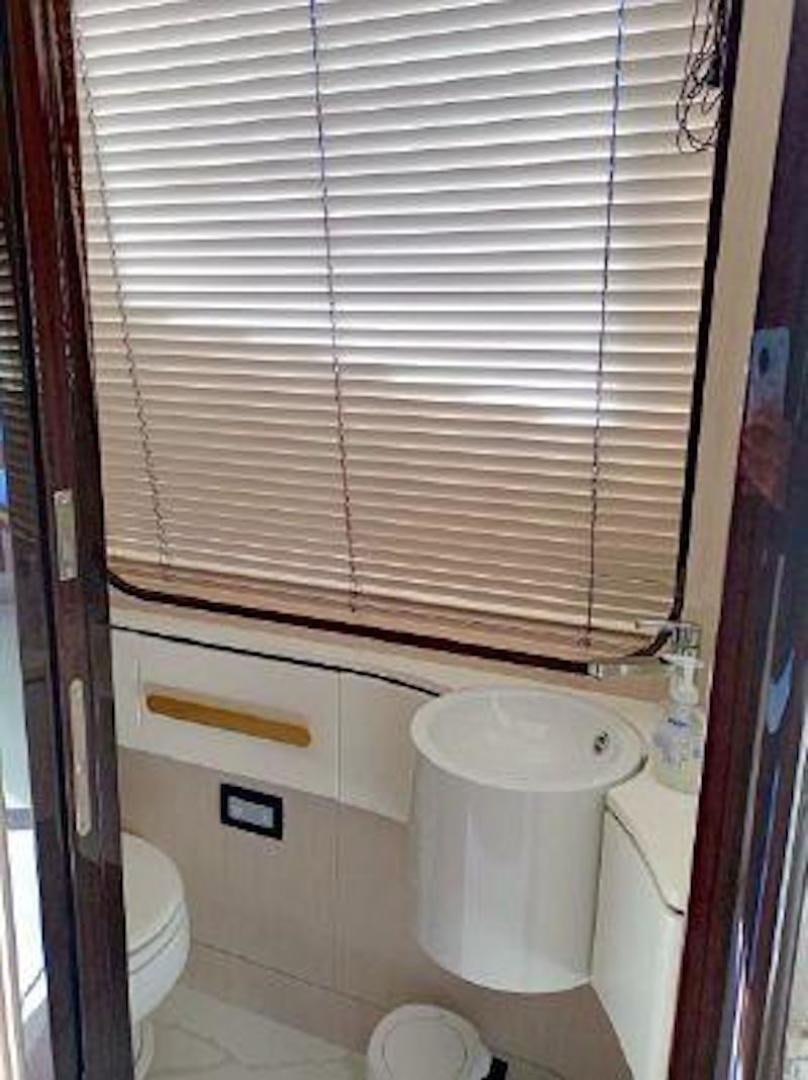 a bathroom with a toilet and a sink aboard NOMAD Yacht for Sale
