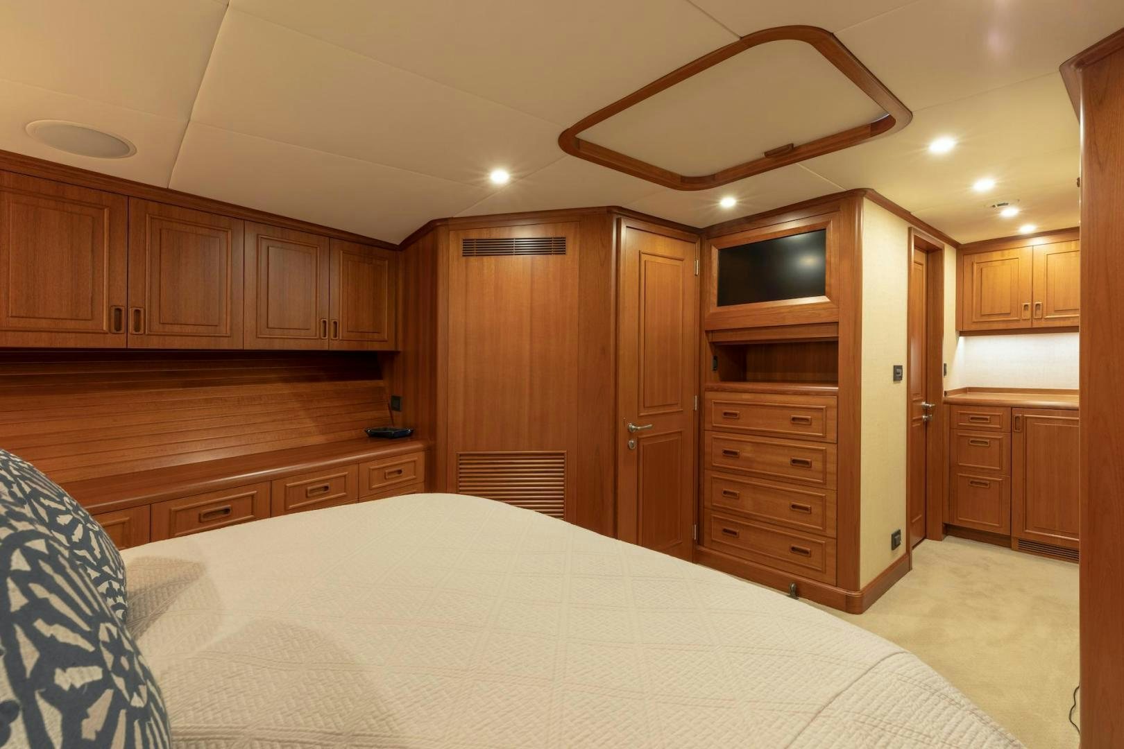 a large wooden kitchen with wooden cabinets aboard CATCH Yacht for Sale