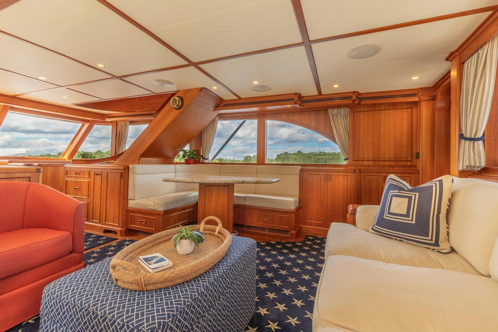 a room with a table and couch aboard CATCH Yacht for Sale