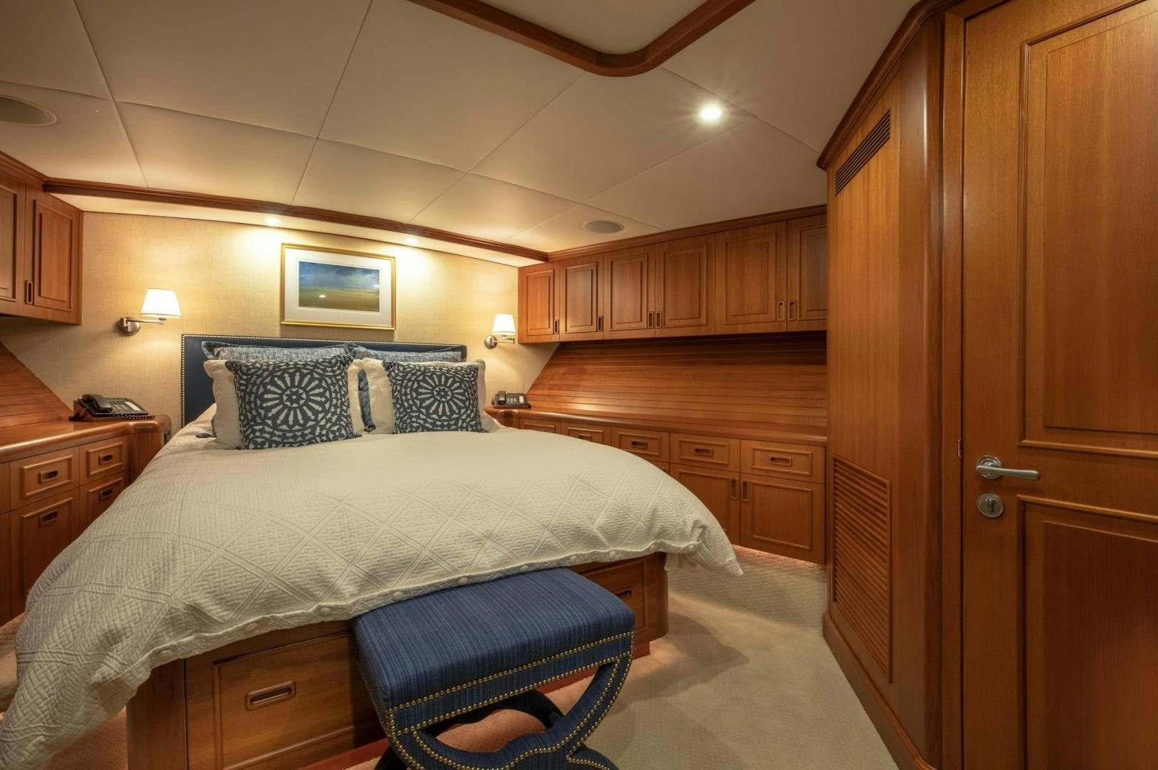 a bedroom with a bed and cabinets aboard CATCH Yacht for Sale