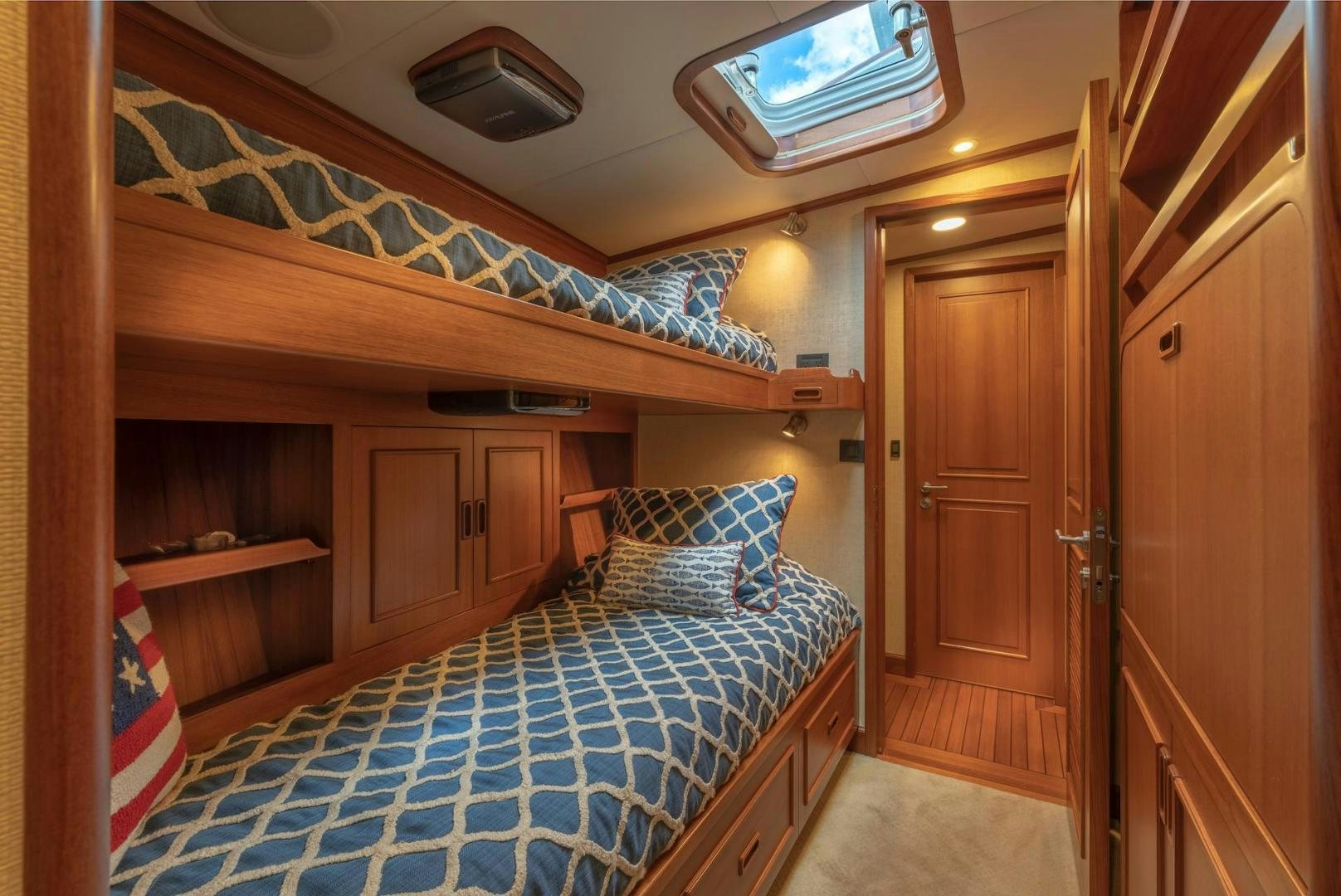 a bedroom with a bed and a wood closet aboard CATCH Yacht for Sale