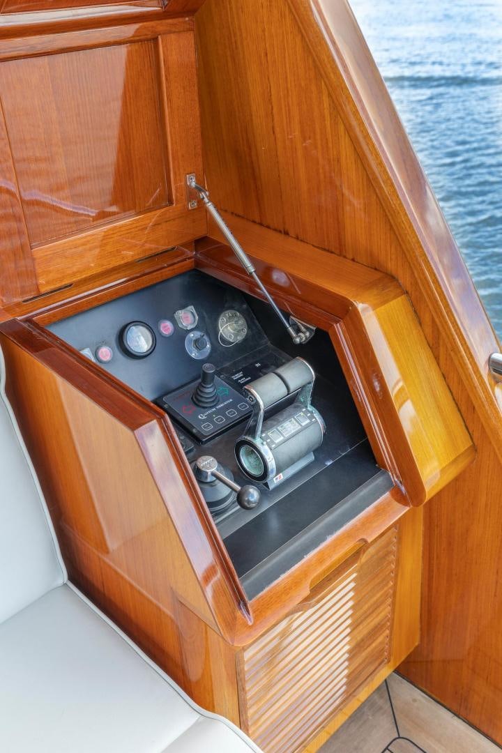 a wood cabinet with a black stove aboard CATCH Yacht for Sale
