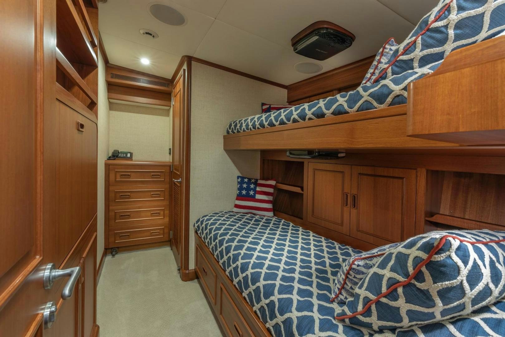 a bedroom with a bed and a dresser aboard CATCH Yacht for Sale