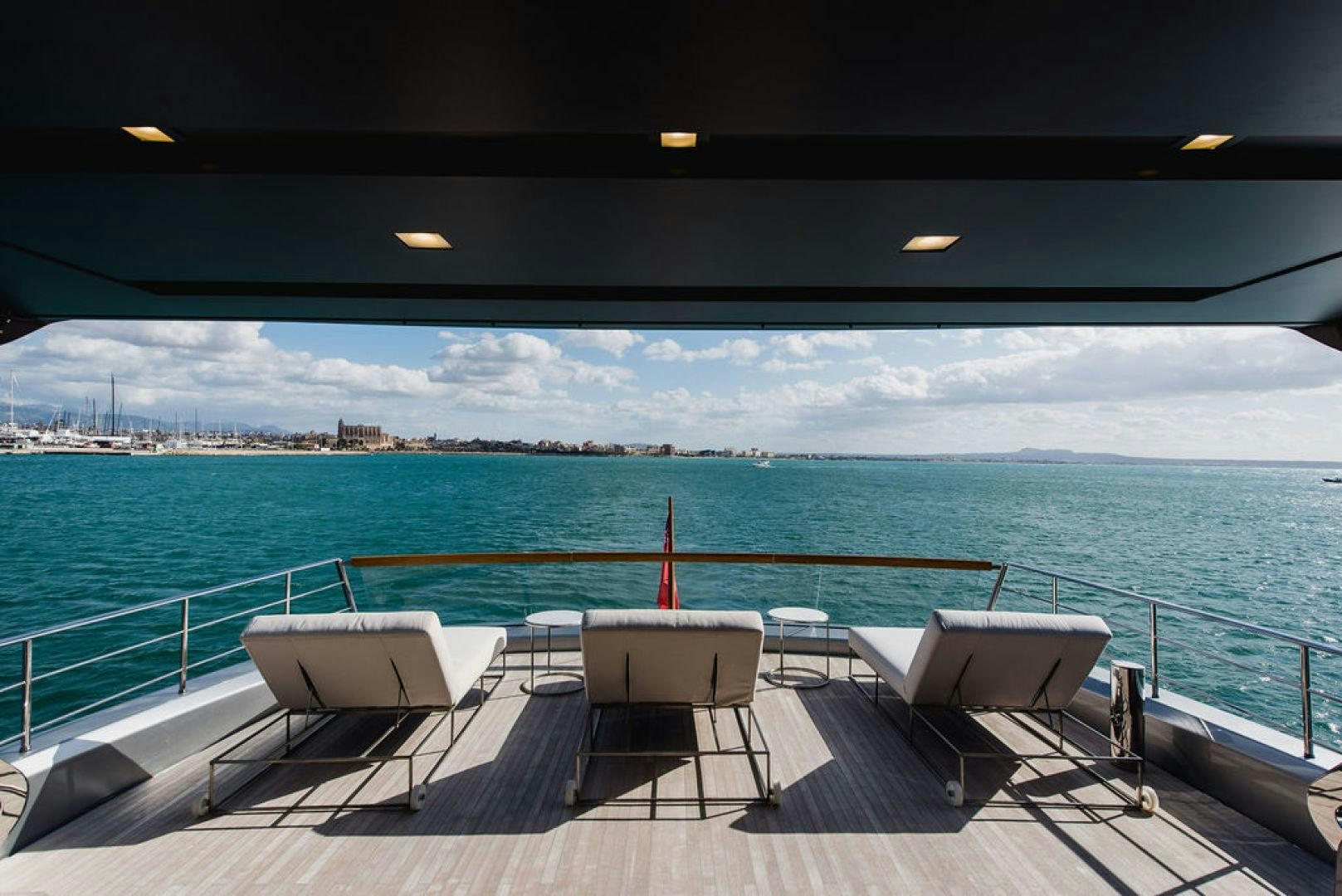 a deck with chairs and a pool aboard ZAZZAZU II Yacht for Sale