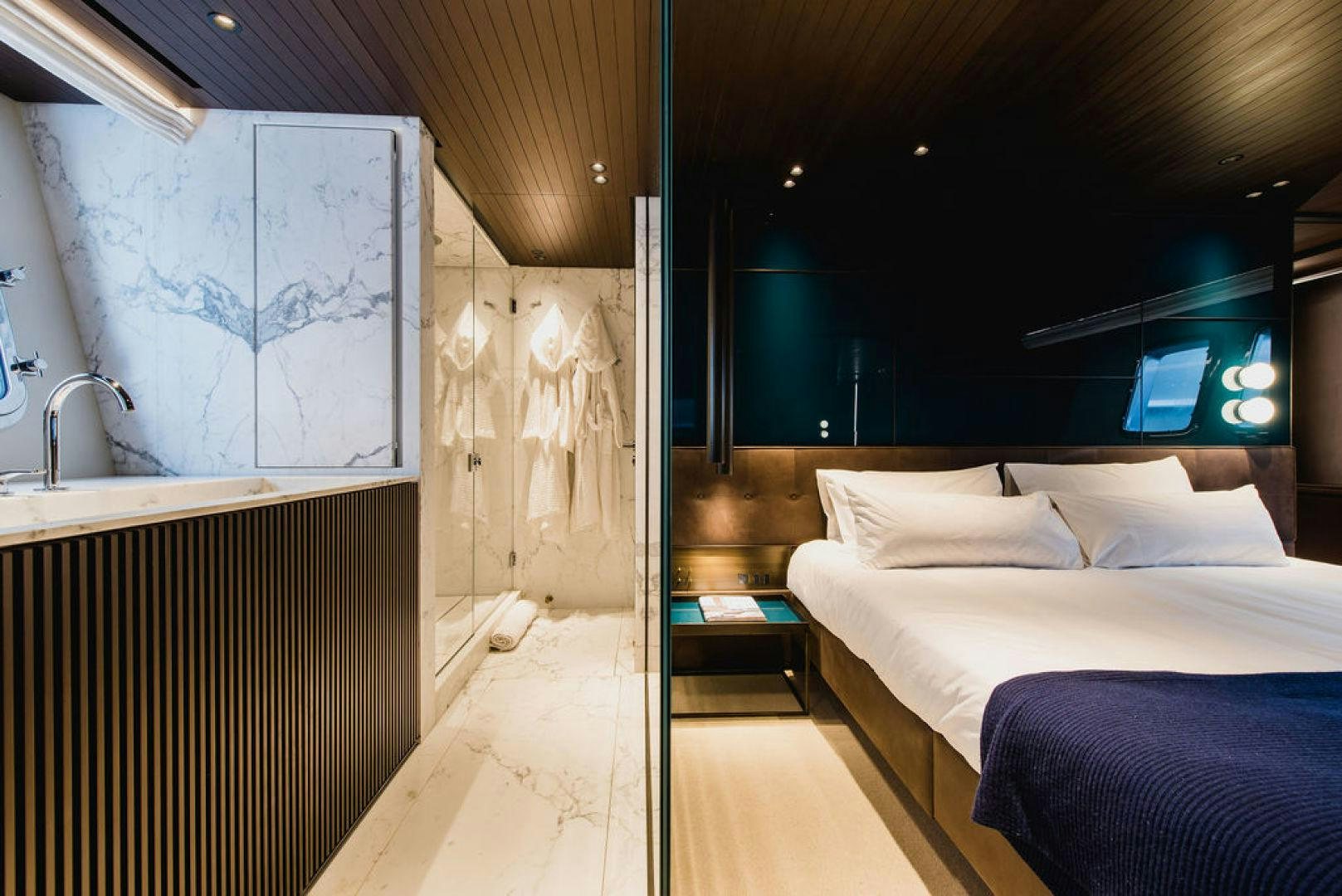 a room with a bed and a sink aboard ZAZZAZU II Yacht for Sale