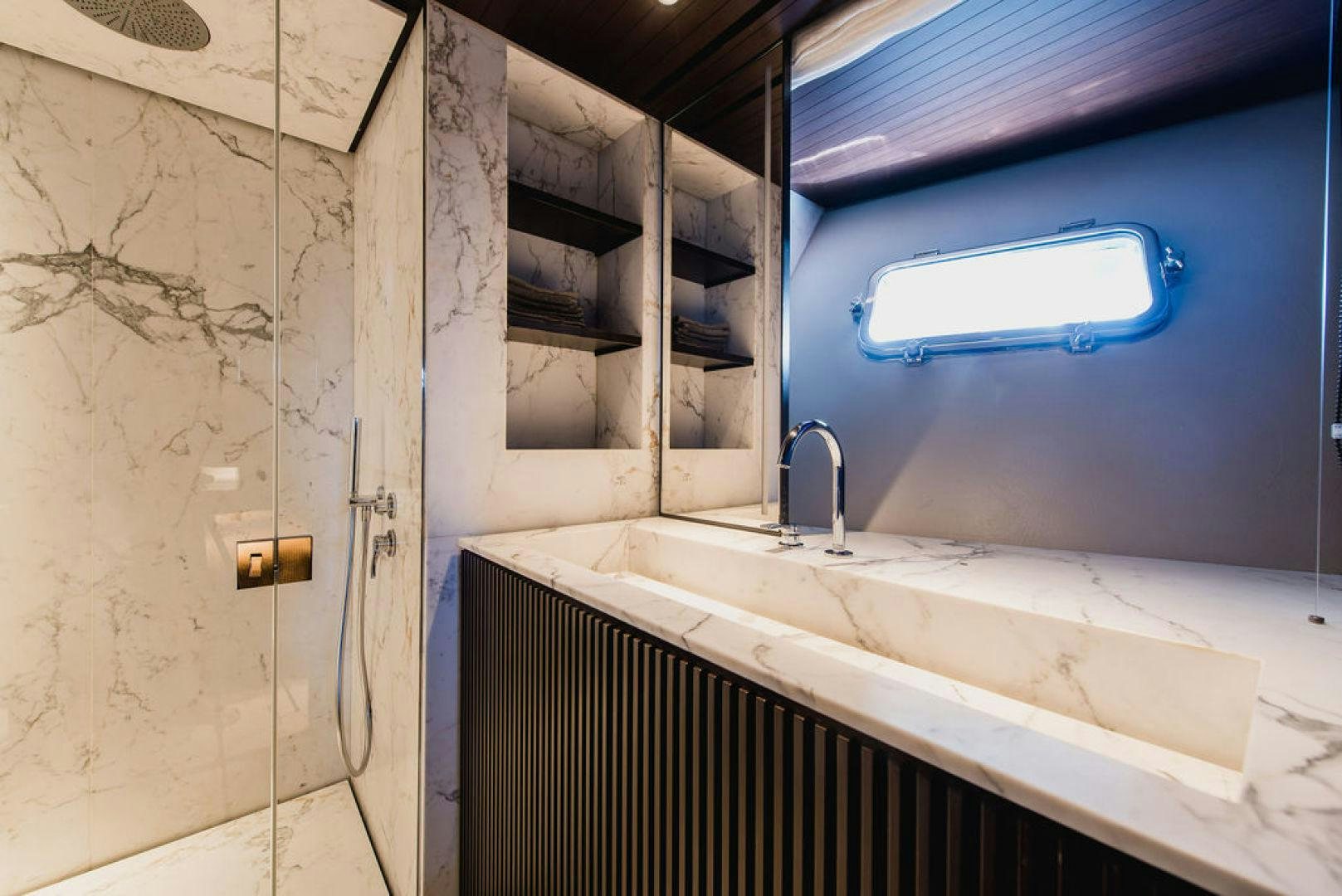 a bathroom with a sink and a window aboard ZAZZAZU II Yacht for Sale