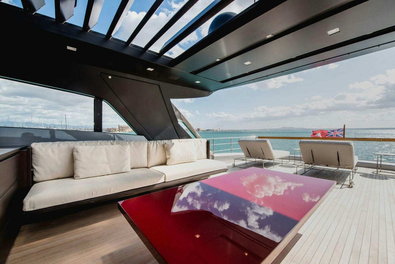 a living room with a large window overlooking the ocean aboard ZAZZAZU II Yacht for Sale