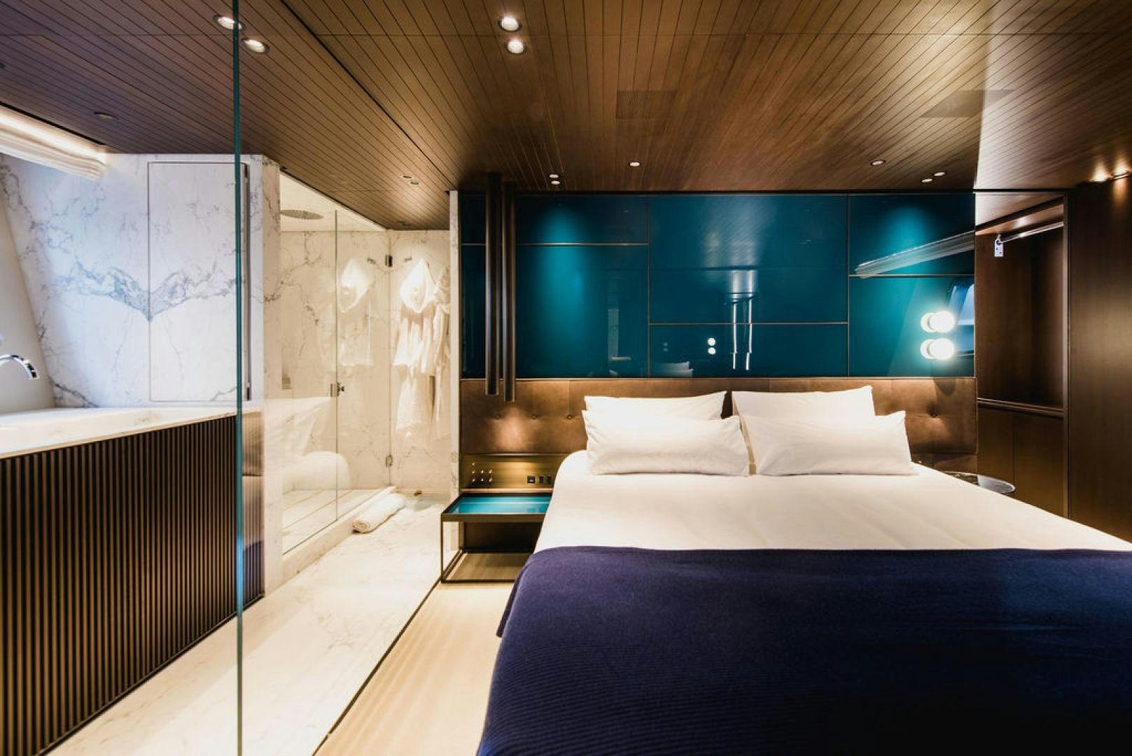 a room with a bed and a window aboard ZAZZAZU II Yacht for Sale