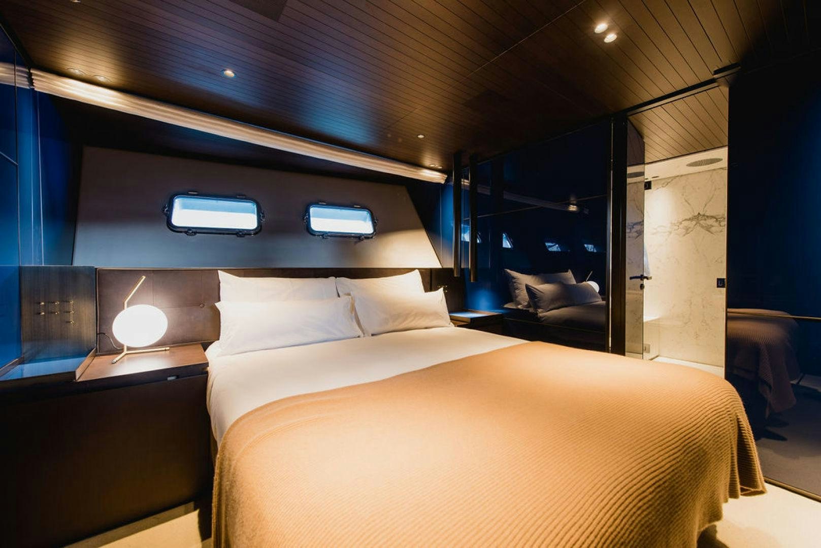 a room with a bed and a window aboard ZAZZAZU II Yacht for Sale